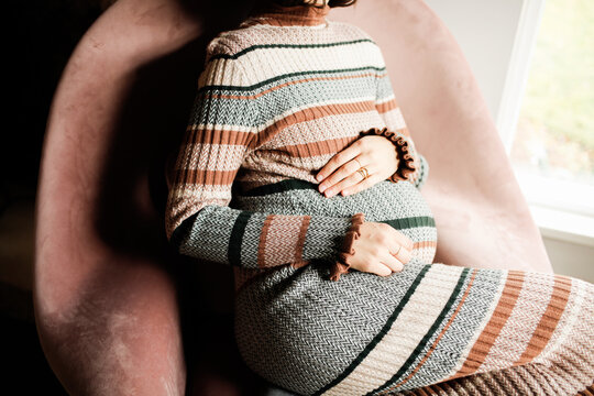 Pregnant Woman Sitting in holiday dress