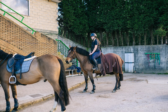 Female rider training horse at equestrian center