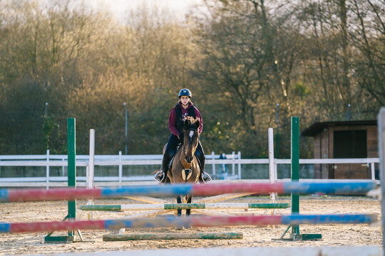 Young woman training an equestrian show jumping horse