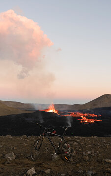 Bicycle parked near volcanic eruption at sunset in Iceland