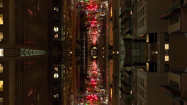 Kaleidoscopic inverted urban canyon creating surreal mirror dimension with endless red lights from busy car traffic in metropolis of New York City at night