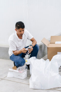 Focused man checking security cam on floor