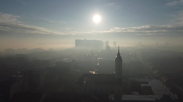 Drone flight above the church in the smog and fog in the morning. Zemun and New Belgrade district, Belgrade, Serbia, Europe