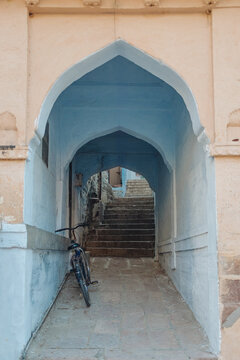 Blue Arch Passageway with Stairs and Bicycle
