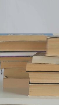 Old Books Scene. Displaying Worn Out Paperbacks With Textured Pages And Warm Shadows. Arrangement Of Antique Paperbacks With Yellowed Pages And Gentle Lighting In Quiet Study Corner
