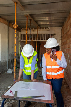 two construction inspectors observe a construction plan