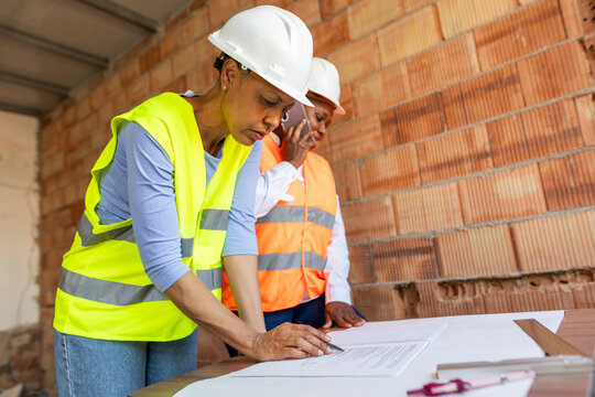 two construction inspectors observe a construction plan