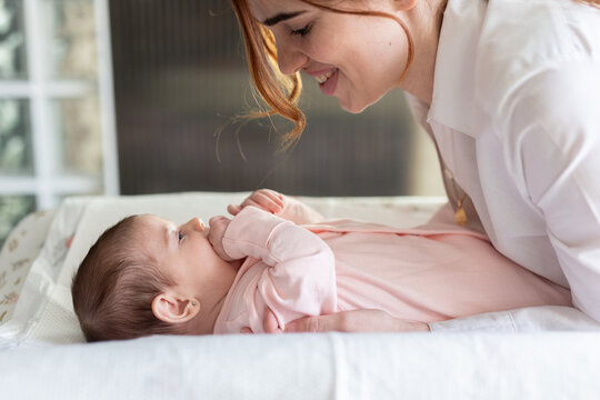 a woman with her baby on the changing table