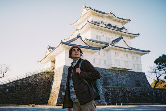 Woman exploring castle during trip to Japan in autumn 