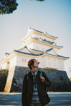 Woman exploring castle during trip to Japan in autumn 