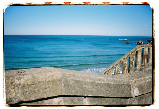 Surfers Enjoying Clear Waters at the Beach on a Sunny Day