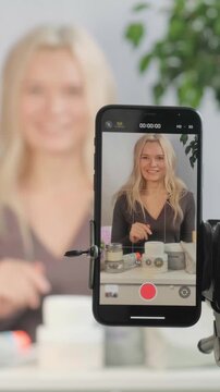 Beauty Influencer Vlogging, Advice with Content Creator, Promotion for Cosmetics Product Live Streaming. Blonde Woman Recording Skincare Tutorial On Smartphone, Jars Of Cream, Serum, Framing Closeup