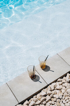 Family enjoys drinks by the pool during summer vacation