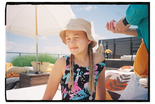 Child enjoying sunny day by the pool in summer attire