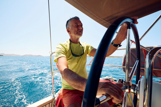Man steering a sailboat