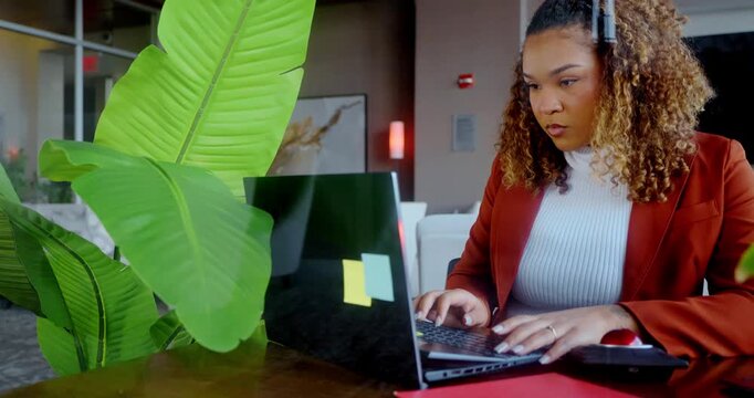 Woman Typing on Laptop in Modern Office Setting