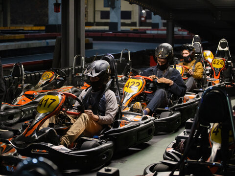 A group of friends is getting ready for a kart race