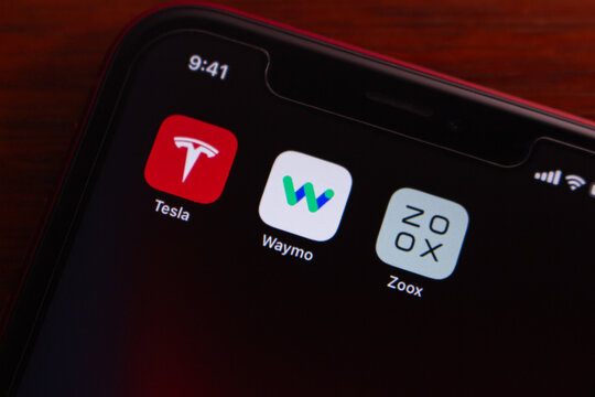 Quito, ECUADOR - Mar 2 2026 : iPhone screen showing Tesla, Waymo and Zoox icons, symbolizing electric vehicles, self-driving technology, and mobility apps today.