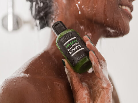 Woman using organic shampoo