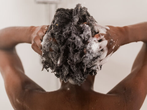 Woman Washing Hair in Shower With Soapy Lather