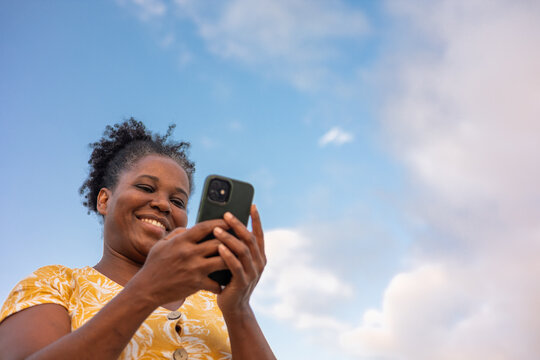A curvy woman using her mobile phone
