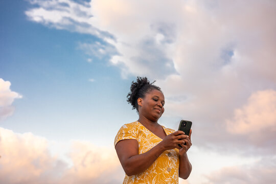 A curvy woman using her mobile phone
