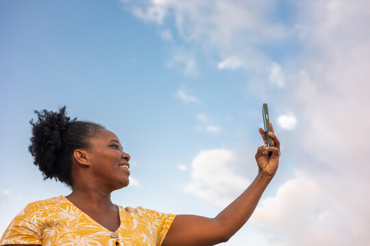 A smiling woman with her mobile phone