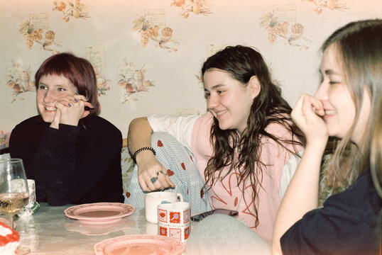 Friends hanging out at home with tea and snacks  
