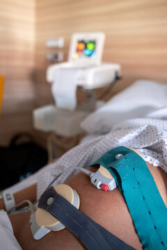 Closeup Of Fetal Monitor Belts On Pregnant Belly In Hospital