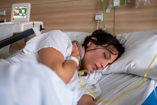 Exhausted Pregnant Woman Lying In Hospital Bed