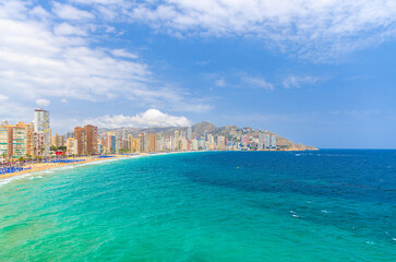 Benidorm cityscape, aerial panoramic view of Benidorm city centre, coastline with skyscrapers buildings on Costa Blanca coast Mediterranean Sea azure water in summer day, Valencian Community, Spain
