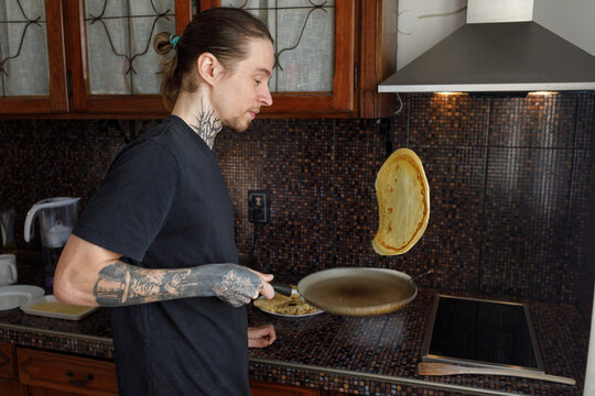 Man flipping pancake