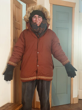 Cheerful woman displaying her outfit for winter