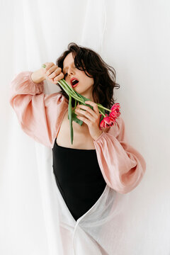 Woman with tulips on white background
