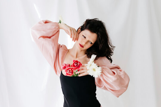 Woman with flowers wearing puff sleeve dress
