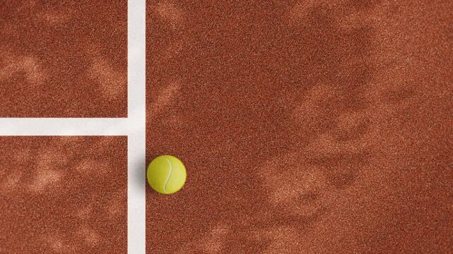 Horizontal 4K tennis court corner with yellow ball resting on clay surface near white line with large copy space sports background footage