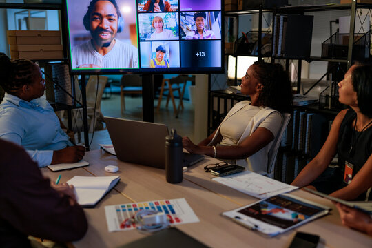 Hybrid meeting, In-person team collaborates with remote colleagues