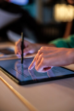 Signing document on tablet with stylus and finger.