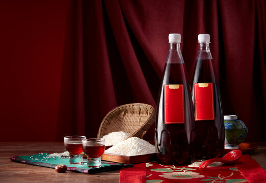 Two bottles of traditional Chinese rice wine and ingredients on table