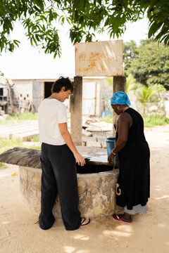 Women drawing water from village well in Senegal