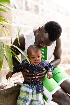 African father bonding with baby son in Senegal
