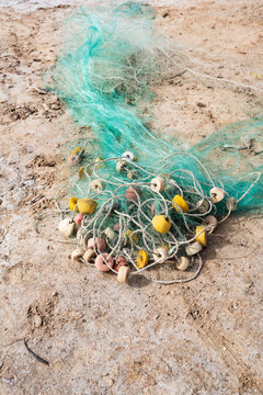 Fishing net with floats on sandy ground in Senegal