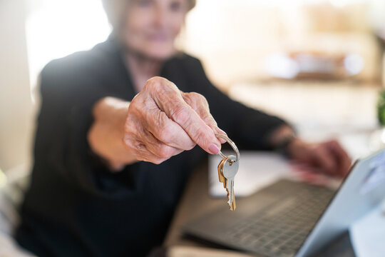 Realtor handing over house keys to new owner