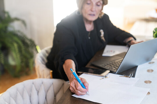 Realtor signing documents at desk