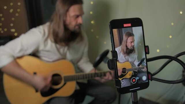 Home Musician Plays Intimate Acoustic Guitar. Indie Artist Singer Songwriter Shares Authentic Acoustic Music on Social Media. Guitarist Influencer Live Streaming And Inviting Live Performance Stream