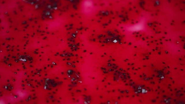 Shiny crimson jelly dotted with tiny dark seeds and soft highlights. Lustrous red currant jam with glossy surface and subtle light reflections capturing rustic charm