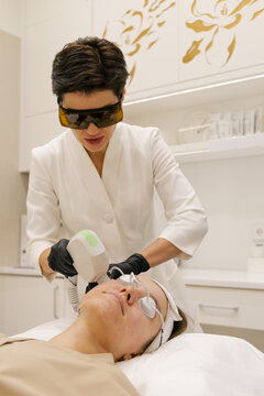 Professional laser facial procedure in modern beauty clinic