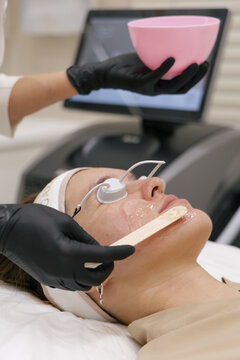 Laser facial treatment with protective eye shields in clinic
