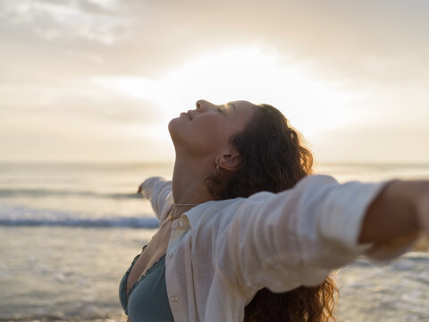 Woman enjoying breathing fresh air at beach 