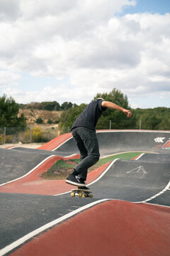Skater Performs Trick on Ramp at Skate Park During Daytime